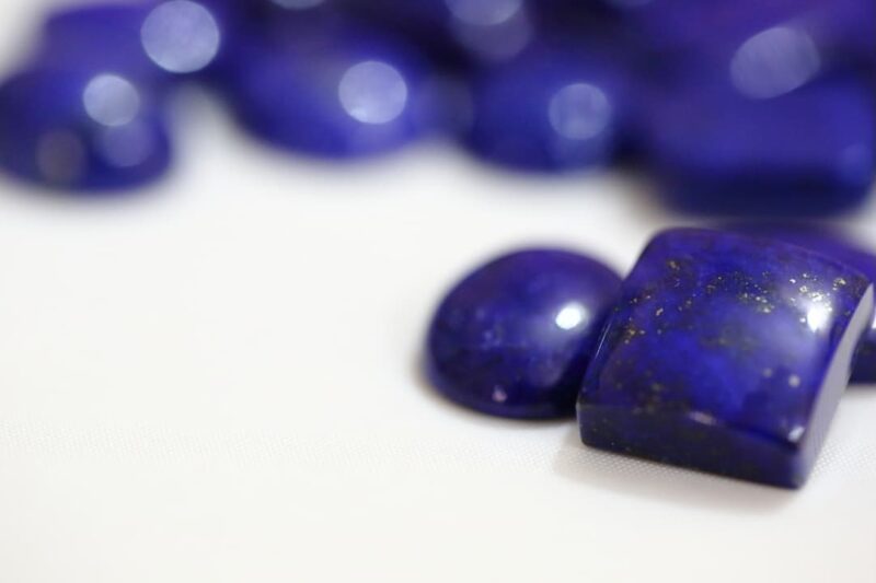 Lapis Lazuli for manifesting love laid on a white tabletop 